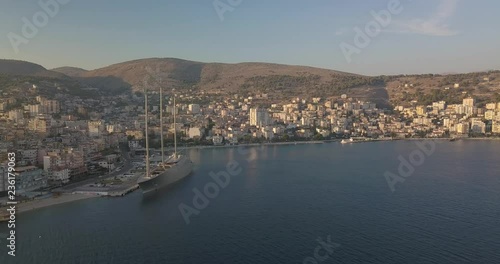 Aerial view of Saranda port in summer 2018 with a luxury boat parked in dock. sunset time , A Yacht . Sarande Albania - 4k