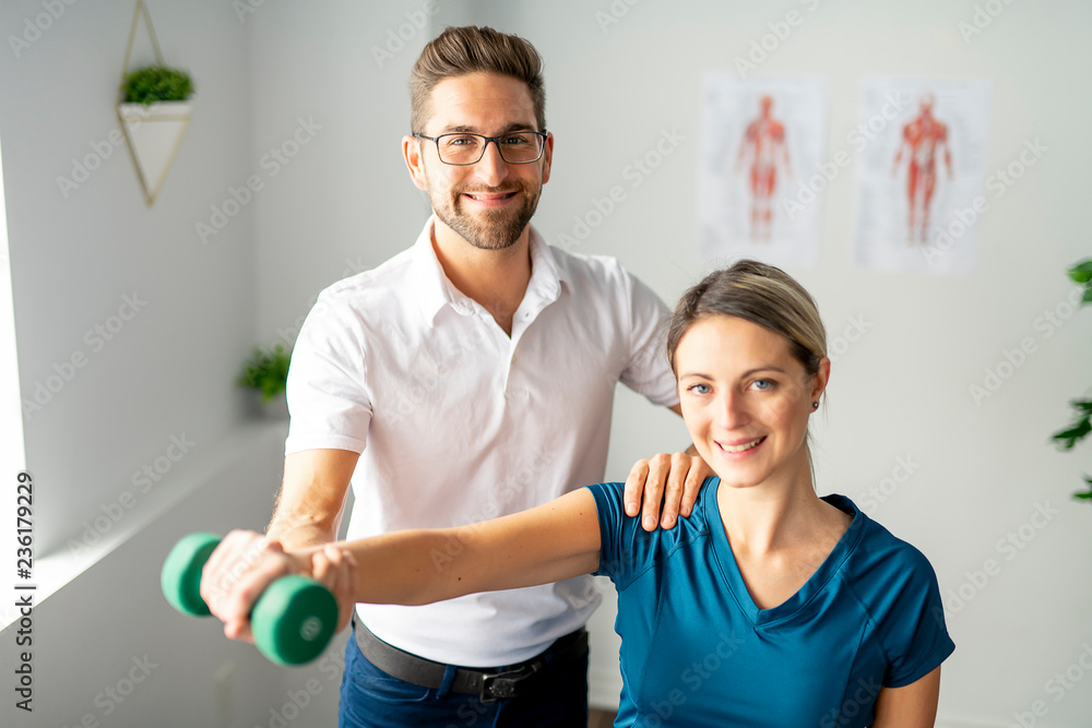 A Modern rehabilitation physiotherapy man at work with woman client A Modern rehabilitation physiotherapy man at work with woman client