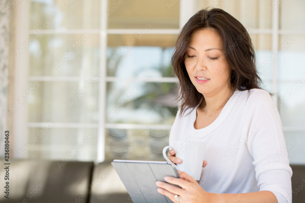 Portrait of an Asian woman smiling and drinking coffee. Portrait of an Asian woman smiling and drinking coffee.