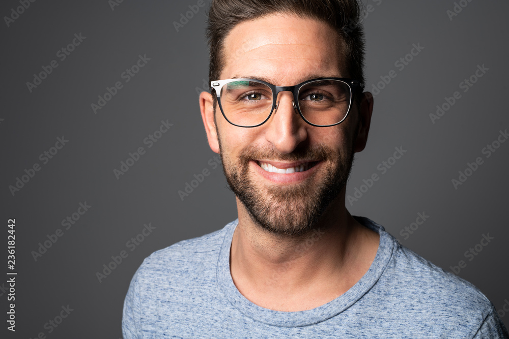 A Handsome man standing over dark grey background Portrait man concept. A Handsome man standing over dark grey background Portrait man concept.