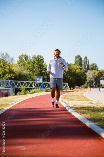 Man running at track in morning time