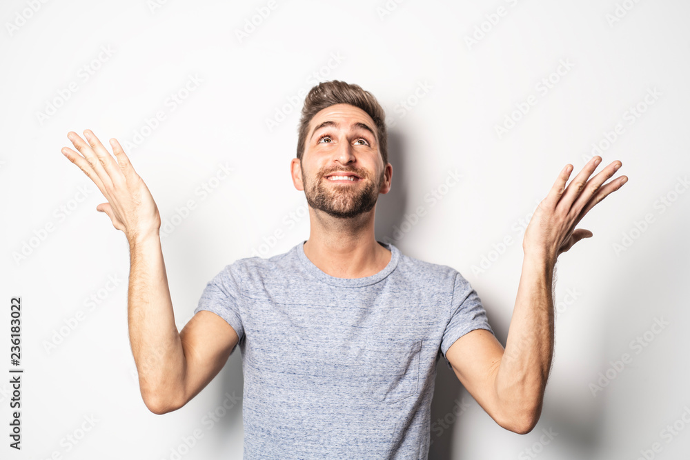 Fototapeta premium A nice guy in studio white, pointing something