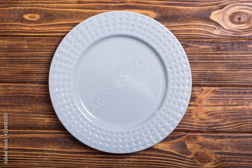 Empty gray plate on wooden table
