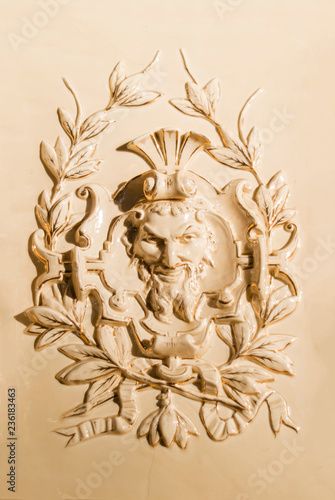 Принти на полотні Perm, Russia - November 24, 2018: tiled panel with a bas-relief on an old firepl