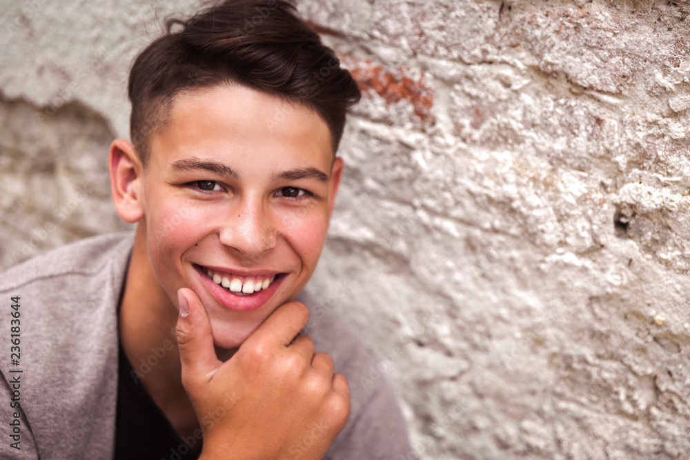 Portrait of the smiling young man near the old house wall Portrait of the smiling young man near the old house wall