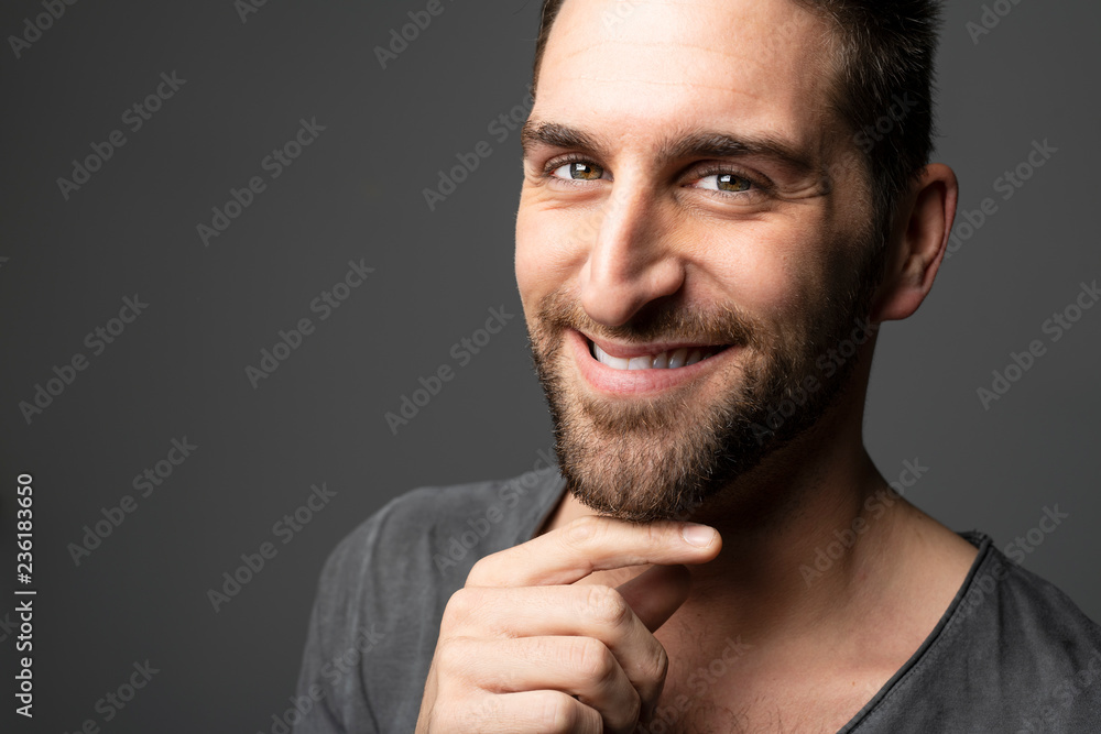 A Handsome man standing over dark grey background Portrait man concept. A Handsome man standing over dark grey background Portrait man concept.