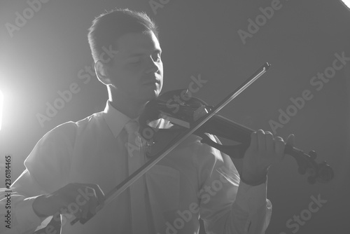 The musician plays the electronic violin. Violin close up. 