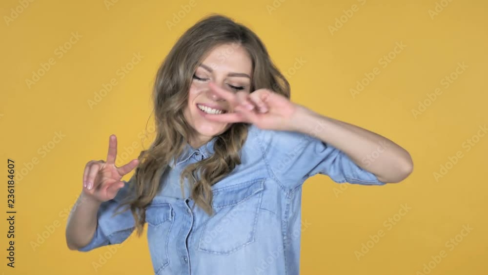 Slow Motion of Young Girl Dancing Isolated on Yellow Background Slow Motion of Young Girl Dancing Isolated on Yellow Background