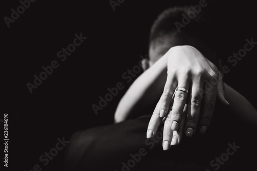 bride's hands elegantly embrace the bridegroom. look from the back. wedding couple