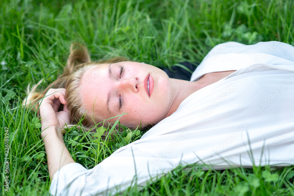 Young woman relaxing on the grass Young woman relaxing on the grass