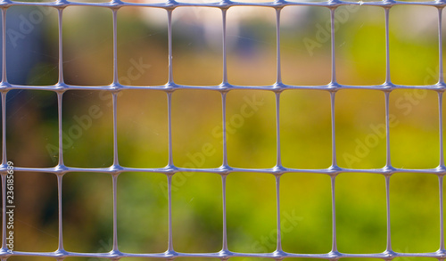 Green old metal mesh with selective focus. Close-up, abstract image