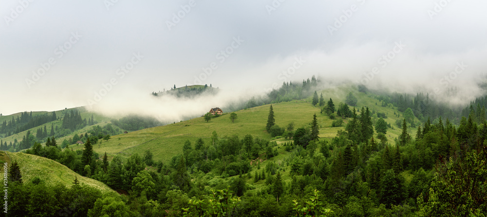 Little house on a green mountain slope