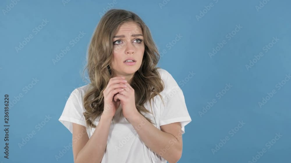 Scared Young Girl in Shock and Fear Isolated on Blue Background Scared Young Girl in Shock and Fear Isolated on Blue Background