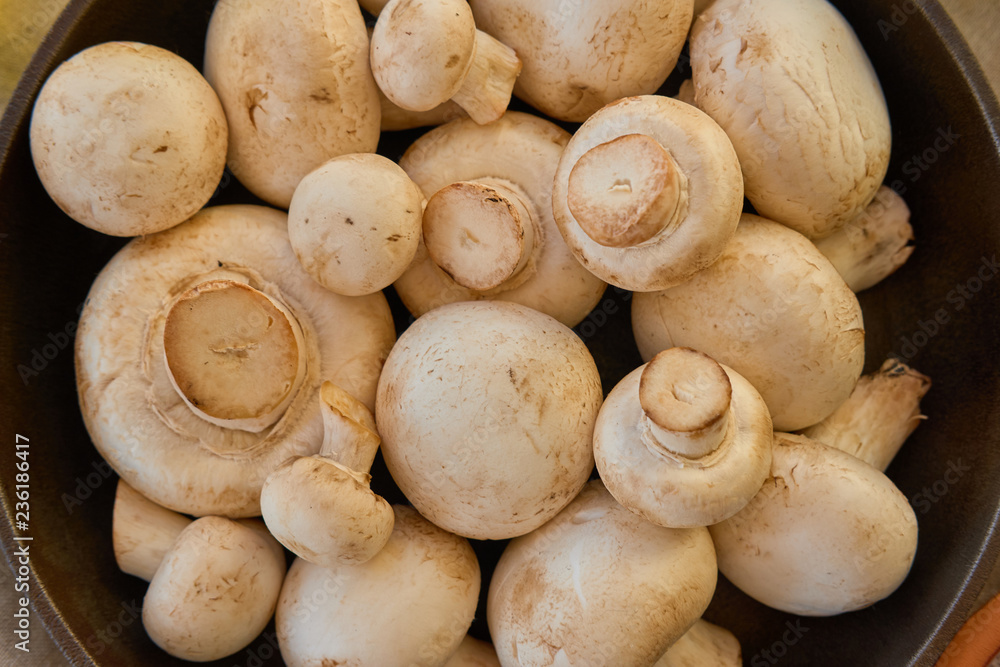 Champignon mushrooms in a cast iron skillet Champignon mushrooms in a cast iron skillet