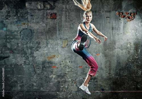 Blonde athlete lady in a jump pose