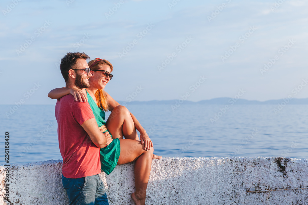 Young couple in love enjoying their honeymoon at the seaside Young couple in love enjoying their honeymoon at the seaside