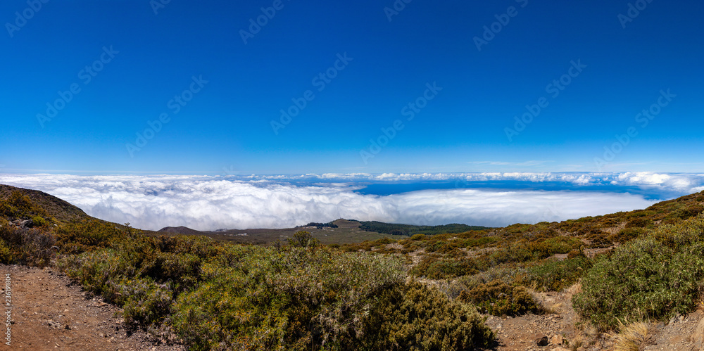 Scenic view from Leleiwi overlook trail of Haleakala National Park. Scenic panorama of underlying slope of a Haleakala mountain with clouds below.