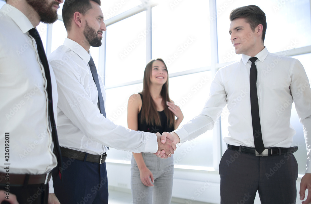handshake between business colleagues in the office handshake between business colleagues in the office