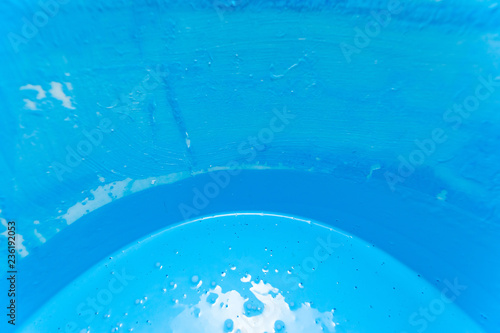 bright light blue paint in a bucket