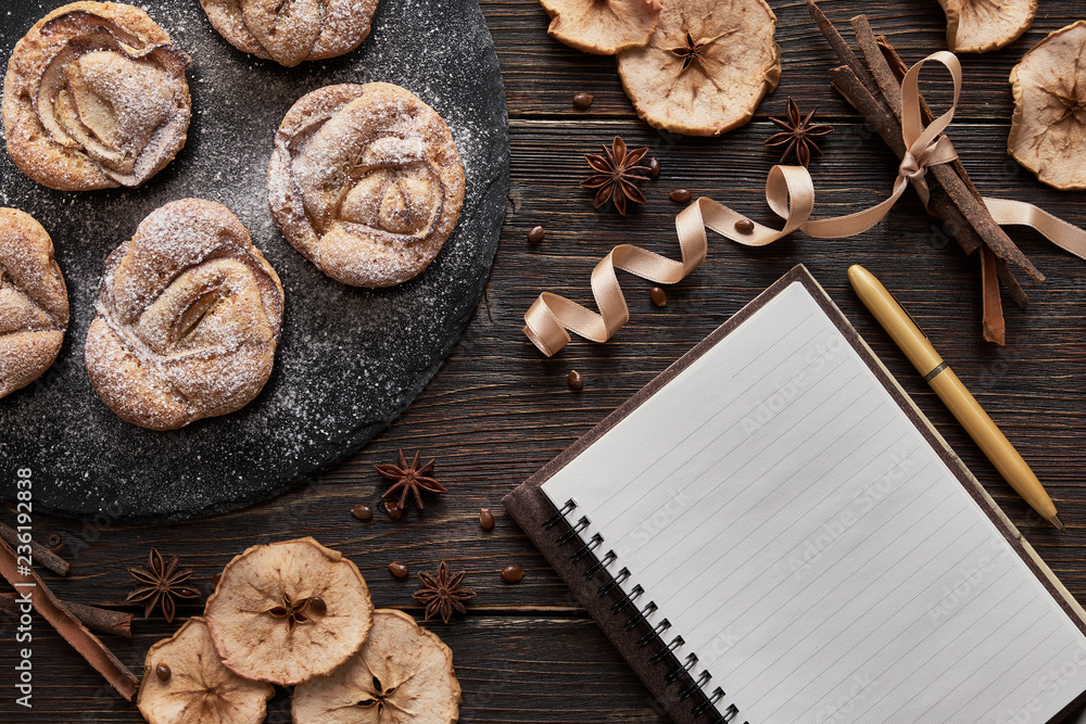 notebook, muffins on black plate