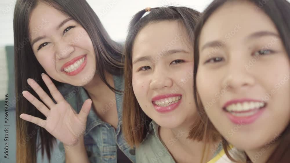 Asian blogger women using smartphone selfie and recording vlog video in living room at home, group of friend enjoy funny moment while lying on the sofa when relax at home. Point of view. Asian blogger women using smartphone selfie and recording vlog video in living room at home, group of friend enjoy funny moment while lying on the sofa when relax at home. Point of view.