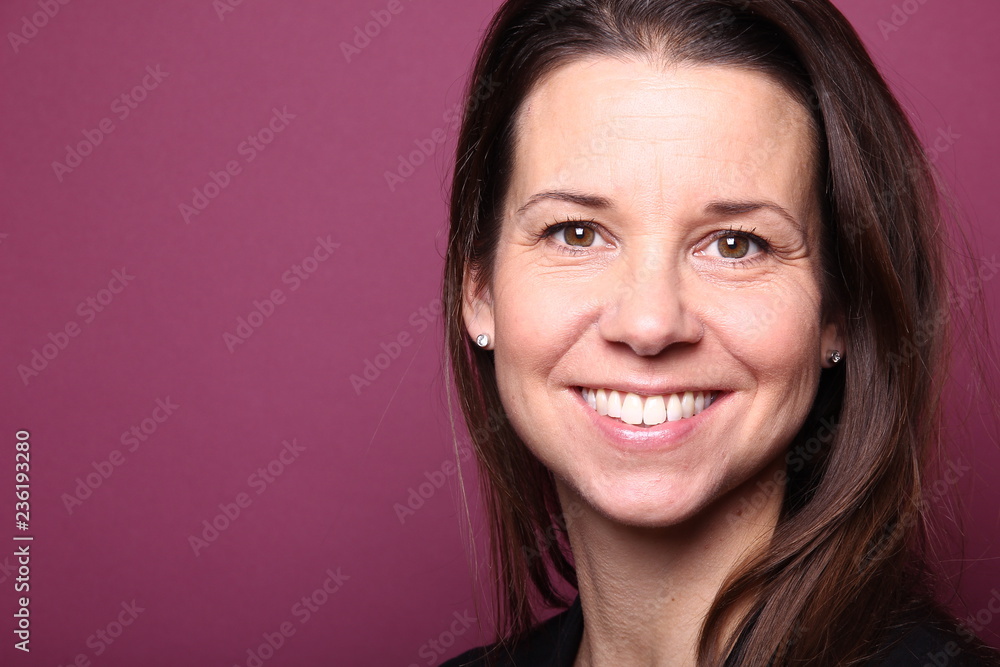 Portrait of a woman in front of a colored background