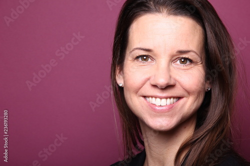 Portrait of a woman in front of a colored background