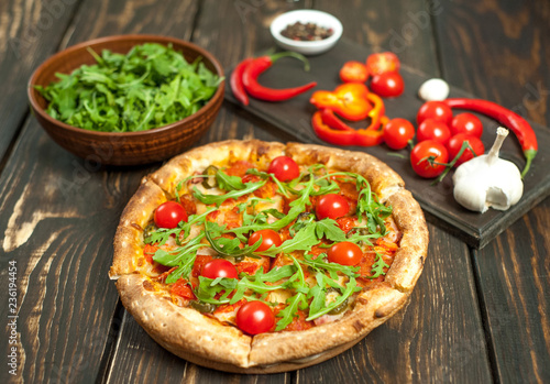 pizza on wood table with ingredients