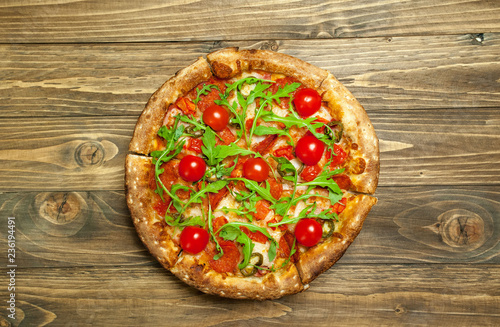 pizza on wood table with ingredients