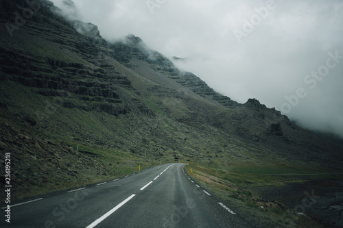 Beautiful magestic cascade mountain formations as seen from inside car during road trip across iceland. Cloudy rainy moody and gloomy day, enjoy winter landscape