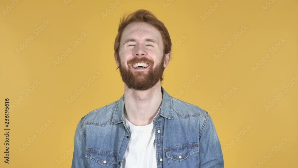 Laughing Happy Redhead Man Isolated on Yellow Background Laughing Happy Redhead Man Isolated on Yellow Background
