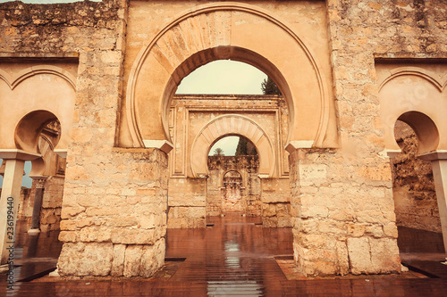 Arches of 10th century ruined palace in Moorish medieval city Medina Azahara in Andalucia region, Spain. UNESCO world heritage site