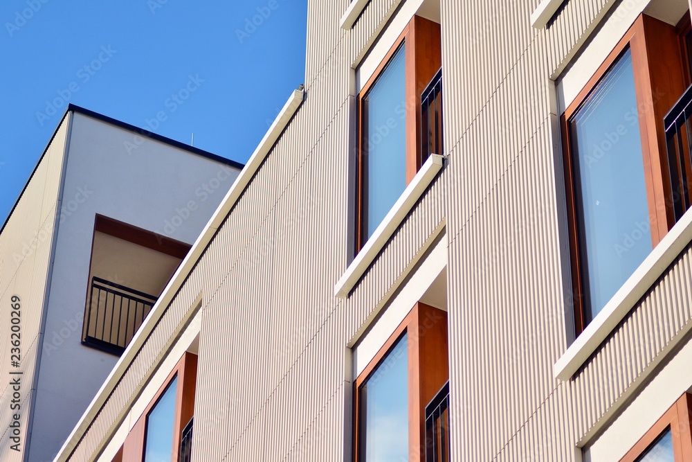 Modern apartment buildings on a sunny day with a blue sky. Facade of a modern apartment building Modern apartment buildings on a sunny day with a blue sky. Facade of a modern apartment building