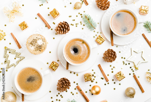 Creative natural layout of Christmas decorations with cups of coffee on a white background. Flat lay, Top view