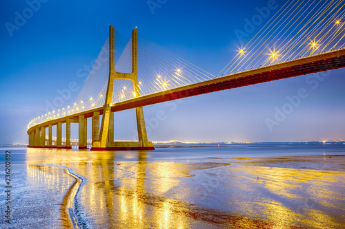 Fototapeta Naklejka Na Ścianę i Meble -  Famous and Renowned Picturesque Vasco Da Gama Bridge in Lisbon in Portugal. Picture Made During Blue Hour.