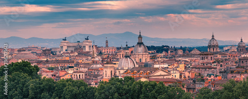 Panoramic aerial wonderful view of Rome with Altar of the Fatherland and churches at sunset time in Rome, Italy