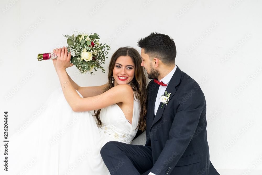 young couple bride groom getting married wedding posed photos at seaside sea beach hairpiece flowers bouquet church