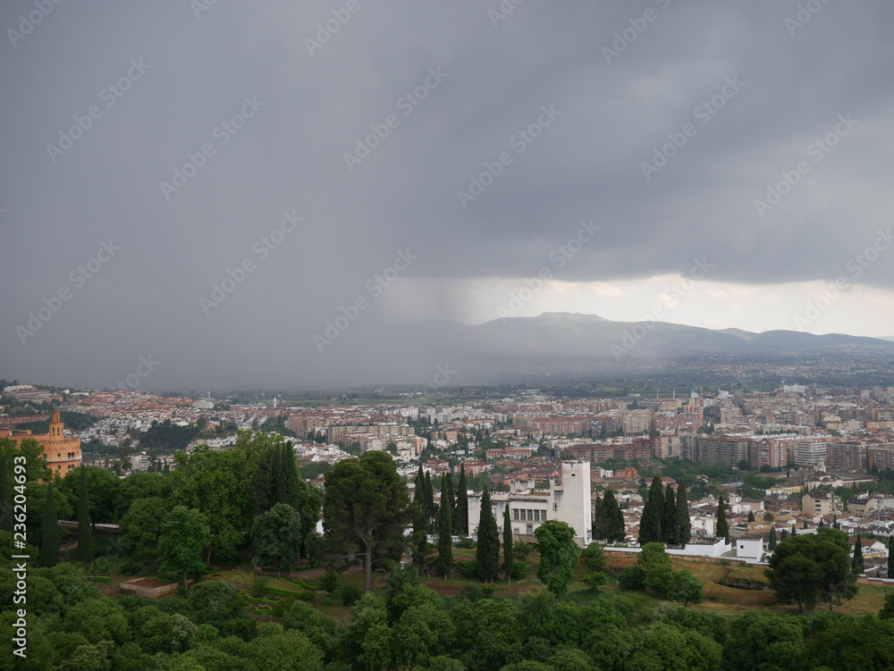 Wall of dark clouds rolling over the city of Granada, Spain