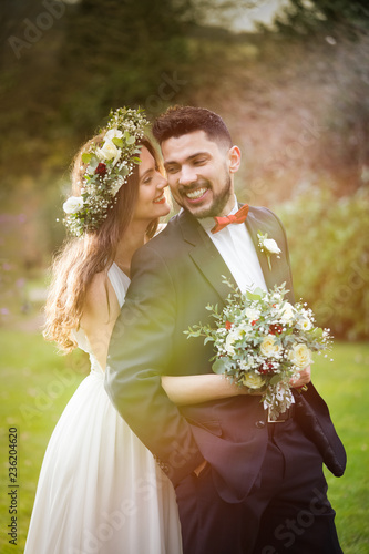 young couple bride groom getting married wedding posed photos at seaside sea beach hairpiece flowers bouquet church