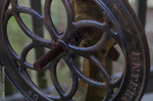 Big vintage iron machinery wheel on rusted axle