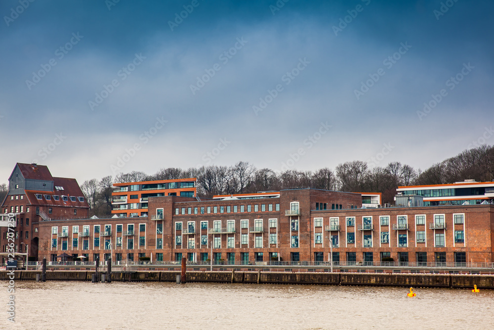 Buildings on the banks of the Elbe River on a cloudy end of winter day