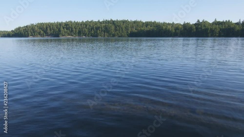 Freshwater lake surface with trees on shore. Spider Lake, Massassauga Provincial Park, Ontario, Canada. photo