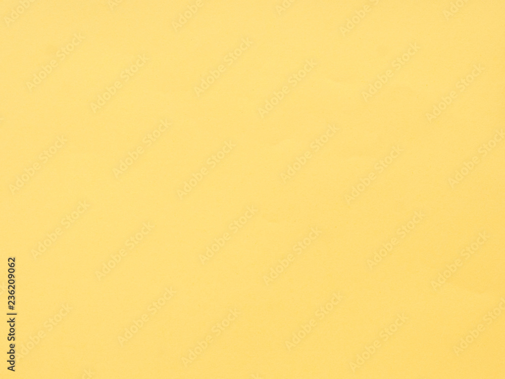 Fototapeta premium Texture of yellow colored paper. Can be used as a background