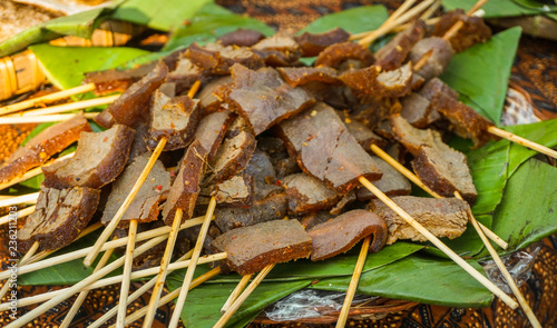 satay sate skin cow with brown color and banana leaf to serve traditional food