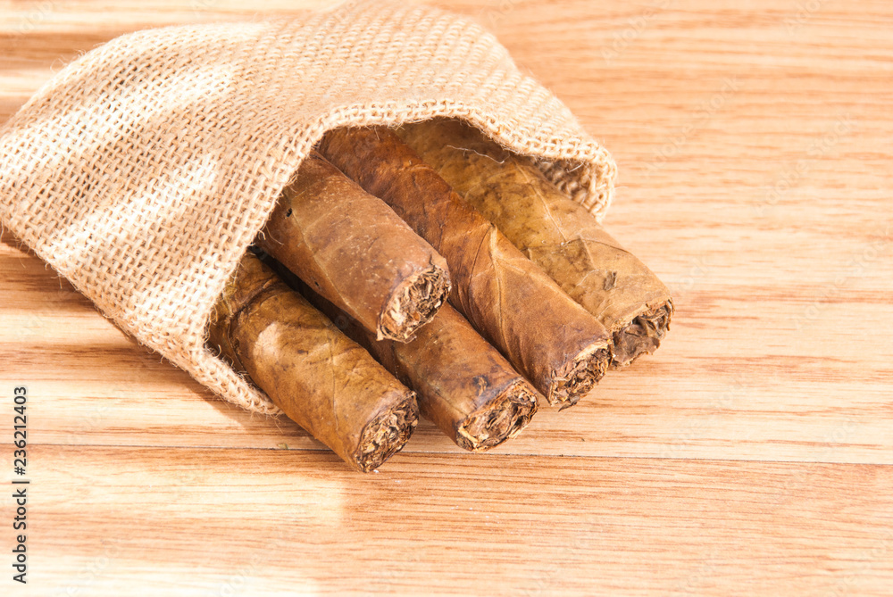 cigar of tobacco on the wooden background cigar of tobacco on the wooden background