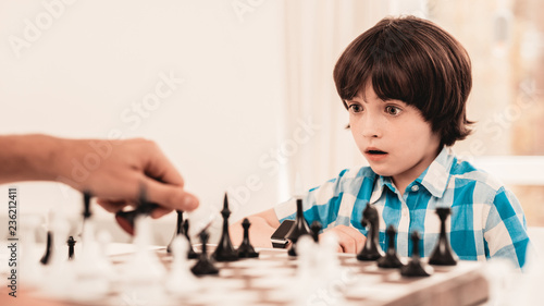 Bearded Father and Son Playing Chess on Table.