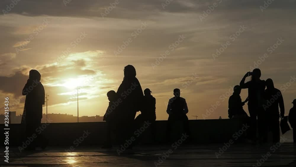 Tourists at sunset in the open plaza near the Hassan II Mosque or Grande Mosquée Hassan II is a mosque in Casablanca, Morocco Tourists at sunset in the open plaza near the Hassan II Mosque or Grande Mosquée Hassan II is a mosque in Casablanca, Morocco