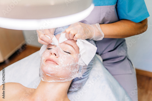 Young pretty woman enjoying a facial mask procedure