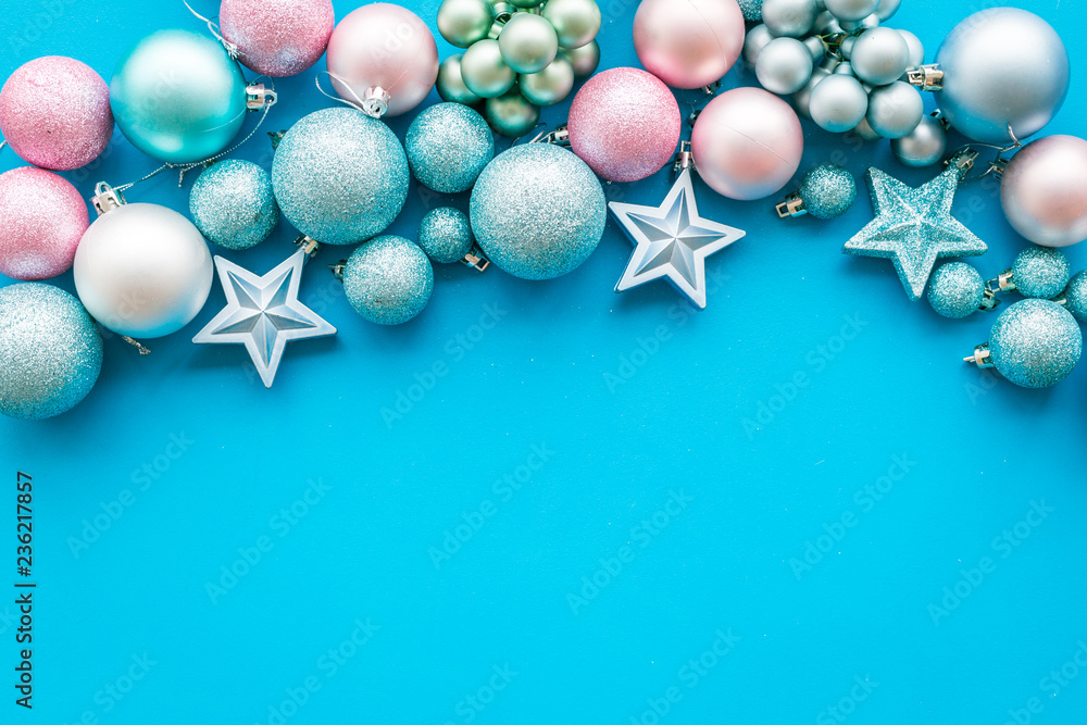 Toys for New Year tree 2019 background. Blue and pink balls and stars on blue background top view copy space border Toys for New Year tree 2019 background. Blue and pink balls and stars on blue background top view copy space border