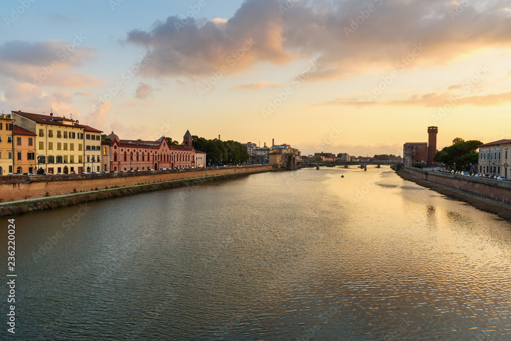 View on embankment of Arno river at sunset. Pisa, Italy